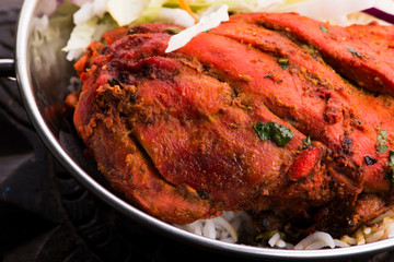 Close-up of a plate of chopped tandoori chicken