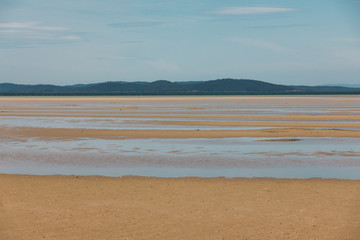 view of Dunalley Beach in Tasmania, Australia with sandbanks and shallow pristine water