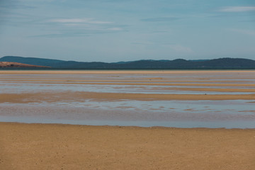 view of Dunalley Beach in Tasmania, Australia with sandbanks and shallow pristine water