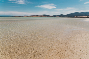 view of Dunalley Beach in Tasmania, Australia with sandbanks and shallow pristine water