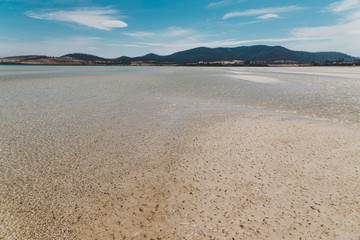 view of Dunalley Beach in Tasmania, Australia with sandbanks and shallow pristine water
