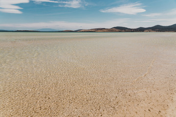 view of Dunalley Beach in Tasmania, Australia with sandbanks and shallow pristine water