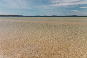 view of Dunalley Beach in Tasmania, Australia with sandbanks and shallow pristine water