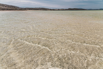 view of Dunalley Beach in Tasmania, Australia with sandbanks and shallow pristine water
