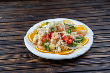 Shrimp in Warm Seafood Salad in a white plate