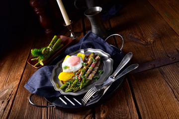 delicious green asparagus wrapped in bacon and egg