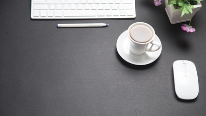 Coffee with computer keyboard and mouse. Modern black business desk. Office