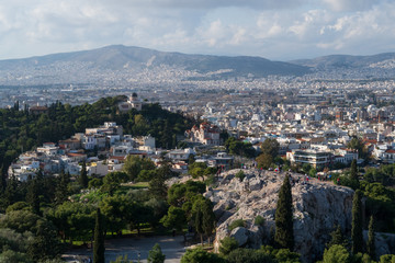 Athens, Greece - Dec 20, 2019: View from the Acropolis of the Athens skyline and the Areopagus (Ares Rock), under a hazy sky caused by dust clouds