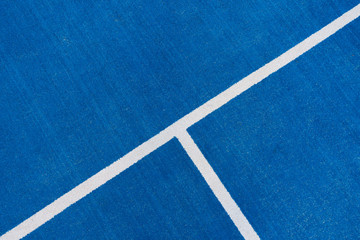 Colorful sports court background. Top view to blue field rubber ground with white line outdoors