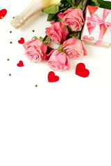 Valentine's day, birthday, romantic  background. Bouquet of pink roses flowers, gift box ,champagne bottle and red hearts confetti isolated on white background with copy space. Top view flat lay