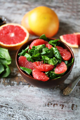 Fresh juicy salad with spinach and grapefruit. Diet salad. Selective focus. Macro.