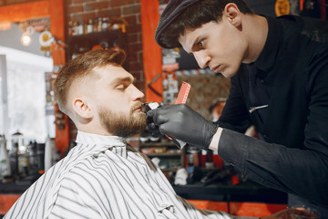 Man with a beard. Hairdresser with a client.