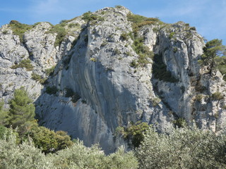 Photo of a beautiful provencal landscape with an imposing rocky hill. This photo was taken in Luberon in Provence.