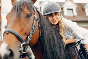 Woman standing with a horse. Lady in a white dress