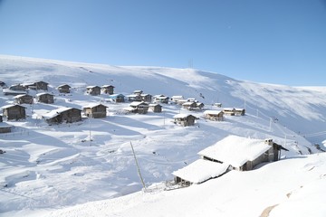 mountain landscape slopes covered with snow can be seen a tree fence and a house.savsat/artvin