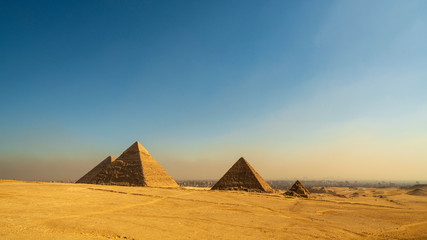 Fototapeta na wymiar Great Cheops Pyramid and the smaller pyramids with downtown Cairo in the background