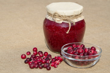Cranberry jam and fresh cranberry berries on burlap