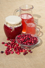 Cranberries, pureed with sugar, cranberry juice and fresh berries in a Cup on a burlap