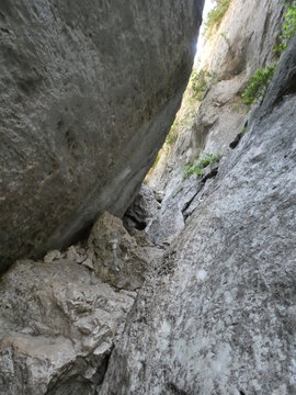 Photo of narrow and stony passage between two imposing rock walls of the Regalon gorges. This photo was taken in the Luberon in Provence...