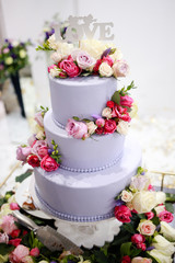 Beautiful large three-tier wedding cake with flowers