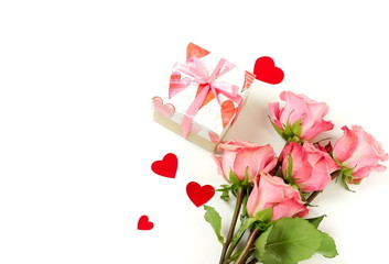 Bouquet of pink roses flowers, gift box  and red hearts confetti isolated  on white background with copy space. Holiday, Valentine's day, birthday backdrop. Top view. flat lay