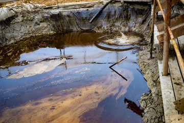 Oil and garbage pollution in the water. Selective focus with shallow depth of field. Industrial...