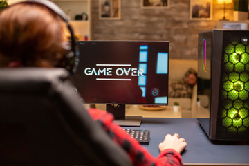 Gamer woman losing at a video game playing late at night in the living room