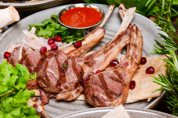 Traditional georgian cuisine - Grilled beef steak with pomegranate and basil close-up on a plate on the table.
