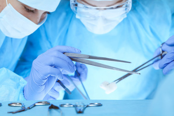 Fototapeta premium Close-up of medical team performing operation. Group of surgeons at work are busy of patient. Medicine, veterinary or healthcare and emergency in hospital