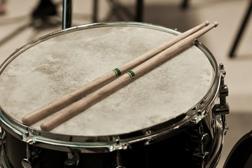 Fototapeta na wymiar Fragment of a drum with drumsticks