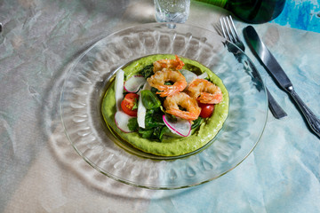 Canape with cucumber, avocado mousse, salmon and shrimp on white wooden background, selective focus