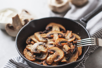 Delicious fried mushrooms with flat bread and herbs on the wooden table