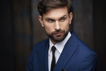 indoor photo of young handsome stylish businessman wearing suit