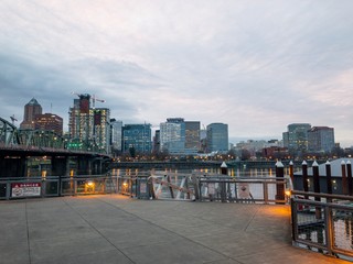 Portland, Oregon cityscape skyline seen from a location by Hawthorne Bridge on the east side of Willamette River in the evening. Portland, Oregon / USA - ciraca 2019.