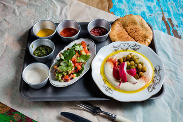 Breakfast with hummus and chickpeas. The cuisine of Tel Aviv.