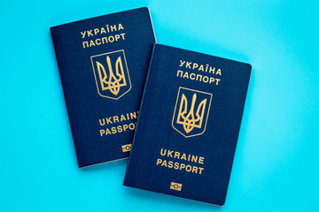 Two ukrainian biometric passports on blue background. Planning vacation concept. International...