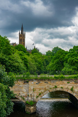 Fototapeta na wymiar Bridge over the River Kelvin in Glasgow with University in the Background