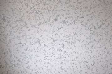 Marble background or texture. The decorative marble plaster painted on the wall mimics the natural marble surface. The combination of gray and white