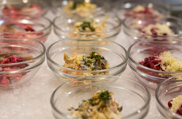 salads in bowls in the open kitchen of the restaurant are in a row