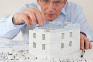 Concentrated architect constructing a house