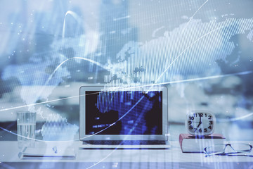 Forex Chart hologram on table with computer background. Multi exposure. Concept of financial markets.