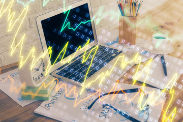 Financial graph colorful drawing and table with computer on background. Multi exposure. Concept of...