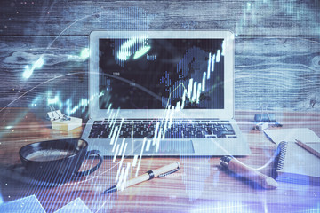 Double exposure of graph and financial info and work space with computer background. Concept of...