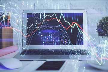 Forex Chart hologram on table with computer background. Double exposure. Concept of financial markets.