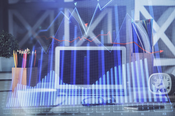 Double exposure of forex chart and work space with computer. Concept of international online...