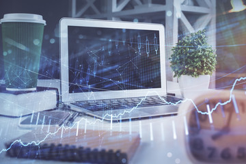 Stock market graph and table with computer background. Double exposure. Concept of financial analysis.