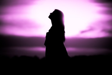 Youth woman soul at pink sun meditation dreaming past times. Silhouette in front of sunset or sunrise in summer nature. Symbol for healing burnout therapy, wellness relaxation or resurrection - 317675683