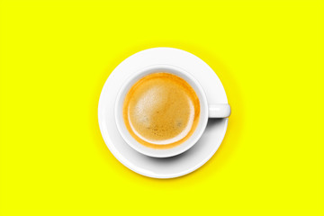 Black coffee in a cup on a yellow background