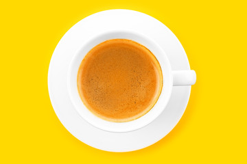 Black coffee in a cup on a yellow background