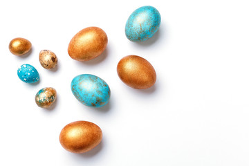 Blue and golden modern easter eggs on a white background. Top view. Isolated.